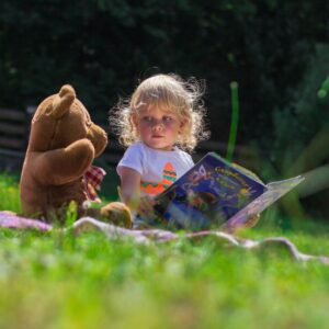 Girl Sitting Beside A Teddy Bear